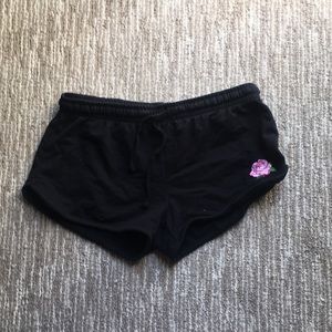 Black shorts with a pink rose